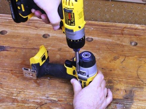 Remove Phillips head screws that hold gear housing in place.