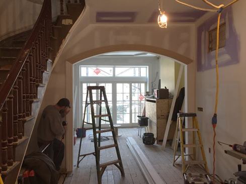 On the first floor, we removed an existing hallway and closet separating the living room from the kitchen, which contributed to the congested feel in the center of the house. We opened up this area, installing an archway at the kitchen entry.