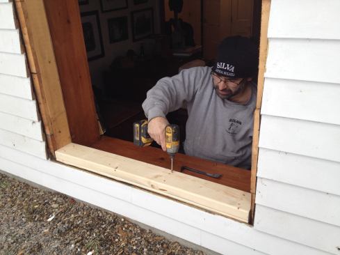 With the window removed, it’s time to work quickly. To get the opening to the new RO size, Manny first builds up the sill with two layers of 2x6 stock. His earlier measurements of the windows confirm the RO space he has to work with.