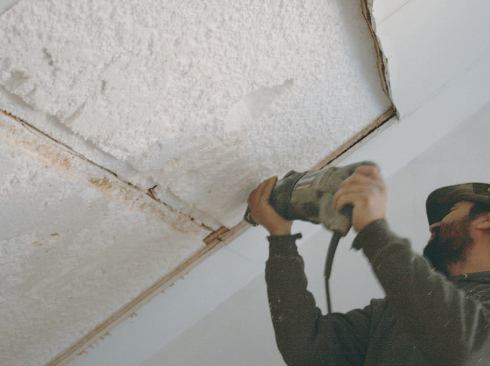 After laying out the skylights from the interior and removing the drywall, the installer transfers the location to the roof.