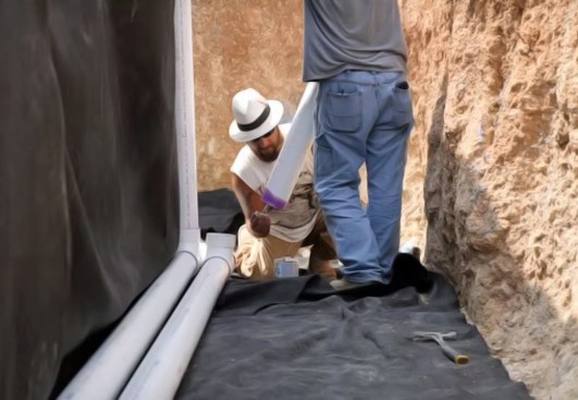 The French drain uses two pipes, each with a clean out installed at every corner.