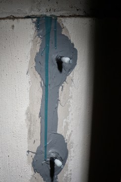 The top of the crack is left open so the resin can overflow, indicating the crack is filled.
