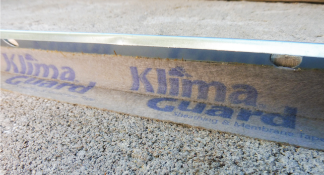 Tape. Make sure the tape is rated to stick to concrete. Do not cover the weep holes.