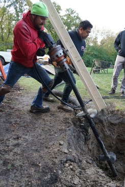 The installers drove the piers parallel to rafter extensions on the A-frame gable.  A total of four helical piers were drilled, two on each side of the A-frame gable.