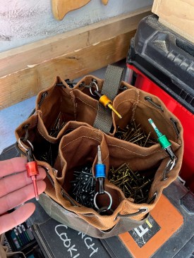 For most jobs, the author leans on his “80% parachute bag” with the fasteners he uses 80% of the time: 2 1/2- and 3-inch GRK general purpose wood screws, 2 1/2- and 3-inch GRK trim-head screws, 1 1/4-inch Kreg pocket-hole screws, and 2 1/2-inch cabinet screws. Each kind of screw has a color-coded bit in a bit holder of the same color.
