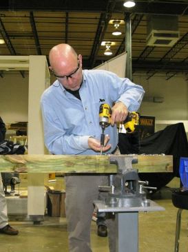 The blogger testing runtime by driving 3/8 x 3 inch lags unpiloted into pressure treated 4x4s.