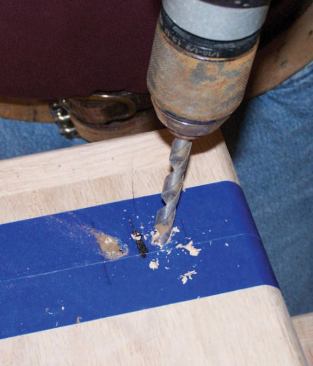 After marking the outside of the shoe, I drill the two 3/8-inch-diameter nozzle holes so that they go all the way through the tread and penetrate the stringer by about 3/4 inch.