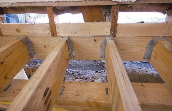 Upside-down joist hangers help transfer roof loads to the new steel beam.