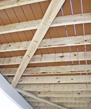 Whenever the decking is installed perpendicular to the joists instead of diagonally, the author uses 2x6 V-bracing to resist racking. The V-braces are attached to each joist with two screws. V-bracing is also used with many brands of grooved composite decking, which is typically installed with clips that do not resist horizontal forces.