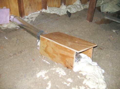 The ceiling opening where the flex duct from the new bathroom fan transitions to rigid duct in the attic was enclosed in a plywood box and sprayed with foam for air-sealing and protection from foot traffic.