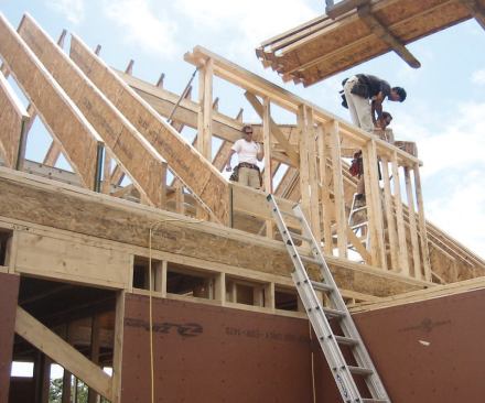 Double 2x4 walls and 14-inch-deep wood I-joist rafters minimize thermal bridging through the frame.