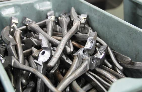 Here is what the pieces for lineman’s pliers look like after machining but before assembly. Look closely and you’ll see cross-hatching on the jaw face, the hole for the rivet, and the beveled edge of the wire cutter.