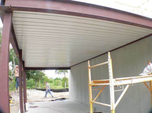 The porch slab cures for about 28 days, after which the shoring can be removed, and finish materials applied to the steel frame.