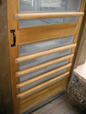 We paint, stain, or varnish the handrail scraps to match the door, cut a simple bevel on the ends, and lay them out in a pleasing array.