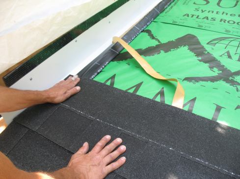 Remove the remaining release sheet from the flashing tape and bed the shingles into the adhesive as each one is placed on the roof. The back-flashed tape helps block water from reaching the underlayment.