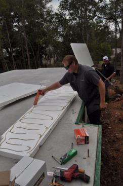 We glued it to the slab, then later shot Hilti cap nails through it. Eventually it got a Sto synthetic-stucco finish in grey to look like a standard slab.