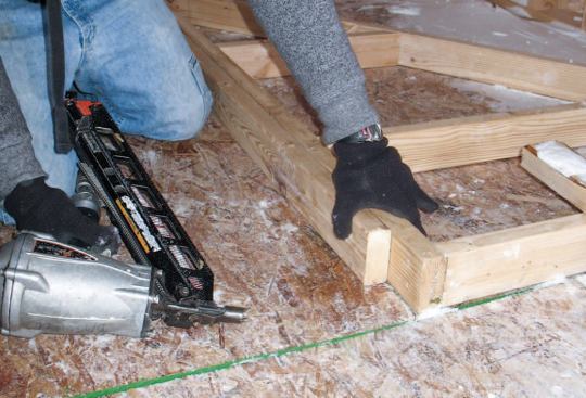 Studs: After nailing the studs in place, we added the double top plates, holding them back 3 1/2 inches to allow for the lapping top plate across the front.