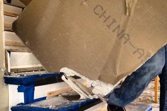 Before the crew starts to rip out drywall, Stockton spends a week protecting vulnerable elements such as stairs.