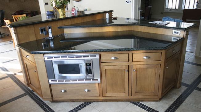 With the countertop in place, the reworked island looks original, but the kitchen bottleneck is gone.