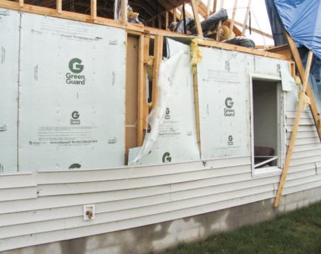 A closeup view reveals that interior drywall — which would not have been present on the attic gable above — probably helped hold the wall together.