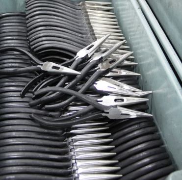 These long-nose pliers have been heat-treated, assembled, ground, etched, and polished. All that remains is to dip the handles.