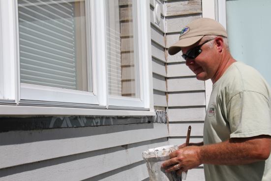 The author sites down a freshly painted exterior sill.