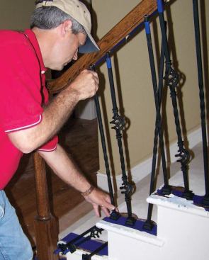 I insert all of the precut balusters into the treads without any epoxy, fit the tops into the glued handrail holes.