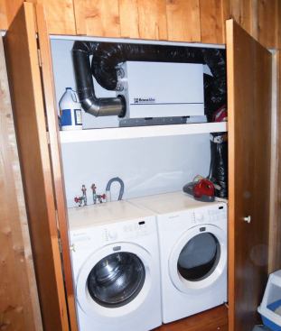 The ERV that supplies the tight retrofitted house with fresh air is installed at head height in an often-used area, making filter changes easy.