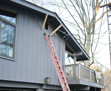 We removed the exterior portion of the old ridge, enlarged the opening at the gable, and added exterior braces to support the overhang.