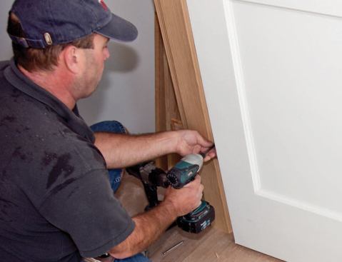 To adjust a hinge that's mortised too deep, the author installs small screws behind the leaf.