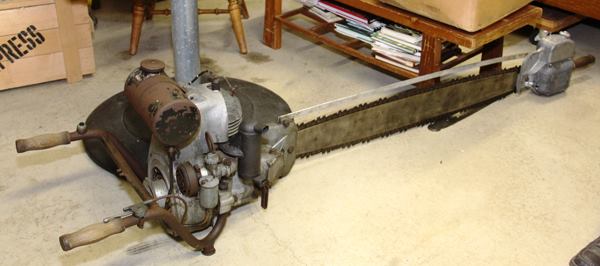 STIHL BDN. This was built in 1938 and like most saws of its day was a two-man machine: one held the handles at the motor and the other held the handle at the end of the bar. Just in from the end is an oiler that feeds oil onto the bottom (cutting side) of the bar. Many early U.S. chainsaws were copies of the BDN—which could no longer be imported from Germany after the start of WWII. 
Click here to see a two-man chainsaw (a 1946 Disston) in action.