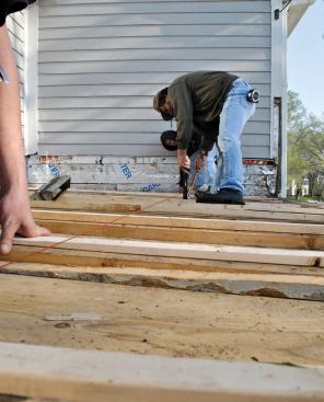Since the sheathing had to be replaced anyway, the author increased the roof slope by adding tapered 2-by sleepers on top of the joists.