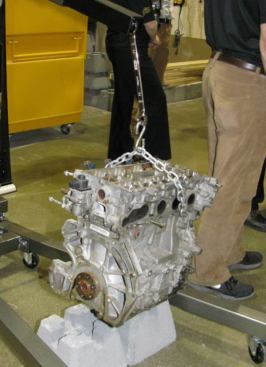 To demonstrate the strenght of these tools, manufacturer put the open end of a wrench on a nut inside the hoise and hung an engine off the boxed end. You can't see it from this angle, but the engine is suspended about an inch above the concrete block.