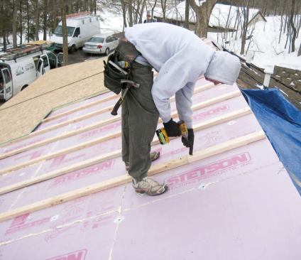 Sleepers installed over the foam provided solid nailing for the new OSB roof sheathing and ventilation channels underneath.
