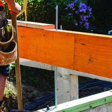 The engineer specced beams under the shear walls that had to be drilled out for hold-downs.