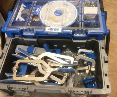 The Kreg Toolboxx costs $65-75 and comes with an assortment of 1,000 plus pocket screws that store in compartments on top. The upper section opens in the manner of the Keter tool boxes to expose a storage area below. The tools and clamps shown here were purchased separately from the box.