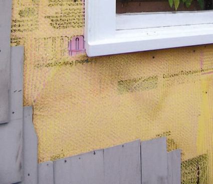 To allow for water and air movement between the shingles and the foam, the shingles were installed over Home Slicker, a 1/4-inch-thick nylon mesh.