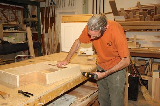 Once the toe-kick base is tacked together, Jeff pre-drills and counter-bores in preparation for a stronger screwed connection.