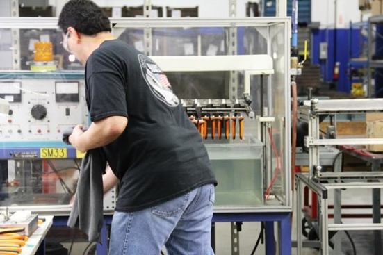 Klein recently introduced a new line of insulated pliers rated to 1,000 volts. This production worker is testing a batch of them by lowering them into a tank of water and running 10,000 volts through it 
(
click here for video
). A buzzer will sound and a light will come on if any handles leak.