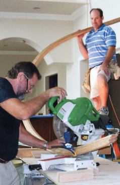 Before making a cut, the author clamps the cutoff end to the saw, supported by a piece of bending mold.