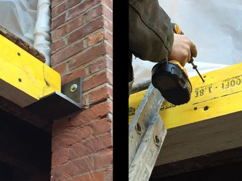 We installed steel angles to support each end of the LVLs, securing the angles to the brick with lag bolts and shield anchors (left). We then sistered the inner LVL to the existing floor joist and fastened the LVLs together with structural screws (right).