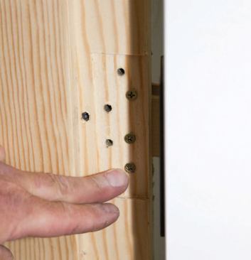 The small screws are backed in or out until the hinge is flush in the jamb.