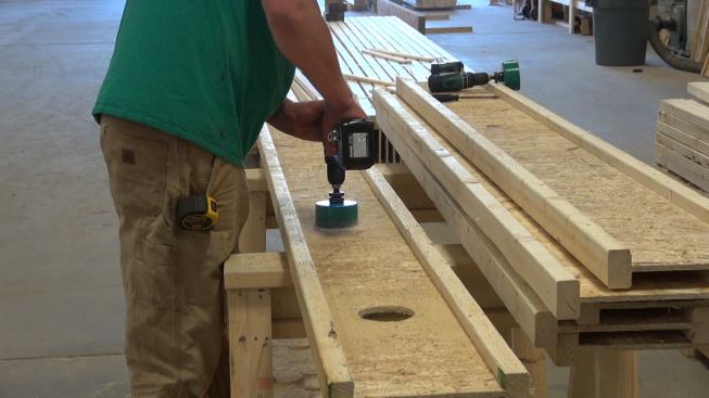 Drilling pressure-relief holes in the wood I-joist webs before attaching the I-joists to the OSB face of the inner wall. These holes turned out to be necessary when dense-packing the I-joist cavities with blown cellulose — otherwise, back-pressure in the cavities impedes and slows the placement of the insulation.