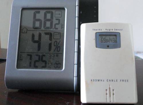 The thin, uneven layer of rock wool covering the floor was later covered with 18 inches of loose-fill cellulose. An inexpensive combination thermometer- hygrometer makes it easy to keep an eye on temperature and humidity in several locations, indoor and out.