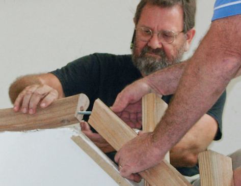 The lower, middle, and upper rail sections are bolted together with rail bolts.