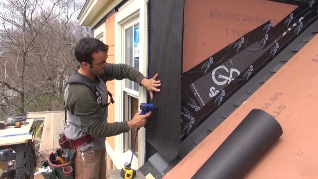 Pollard attaches asphalt felt paper to the sheathing with stainless steel staples. The staplegun has an adjustable air pressure regulator so that staples won't get over-driven through the paper.