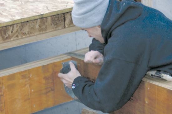 A pneumatic palm nailer helps for driving hanger nails into the hard engineered beams.