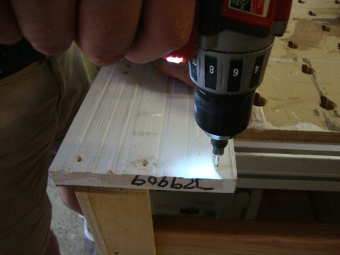With all the prep work completed on the door slab and the jamb, Greg predrills the jamb legs for the screws that will attach them to the head and sill.