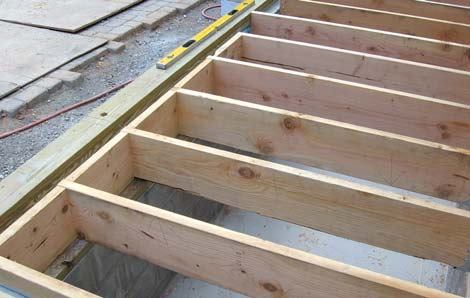Which rest on a flashed PT sill. Full-depth blocking between the joists takes the place of a rim joist.
