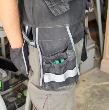 A series of deep pockets hangs from the front left side – a full width pocket in back and three tall narrow pockets in front. The vest came with a stretchy belt. I assume it was there so you could transfer some of the weight from shoulders to waist. I don’t load the vest up so I got rid of the belt because I never used it.